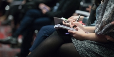 Woman using a notebook in a class